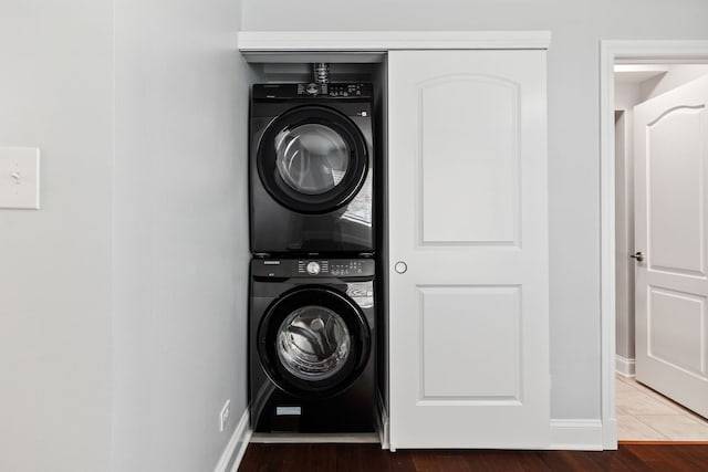 8232 Niles Center Rd Unit 101, Skokie, IL 60077 - washroom featuring stacked washer and clothes dryer and baseboards