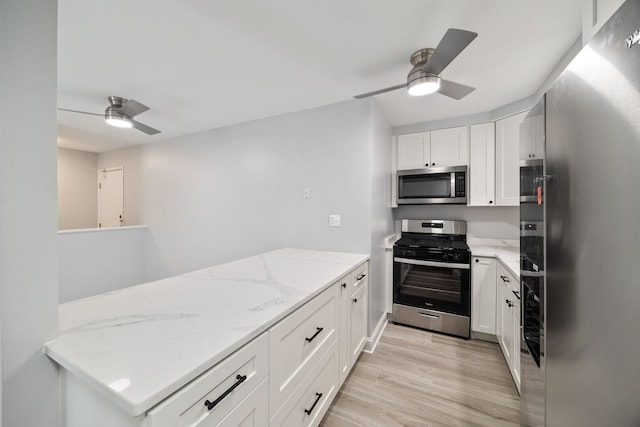 8232 Niles Center Rd Unit 101, Skokie, IL 60077 - kitchen featuring stainless steel appliances, ceiling fan, light wood finished floors, and white cabinetry