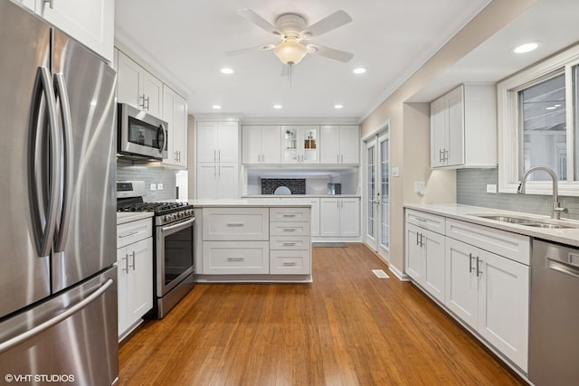 647 Farnham Ln, Wheaton, IL 60189 - kitchen with stainless steel appliances, white cabinets, light countertops, recessed lighting, and ornamental molding