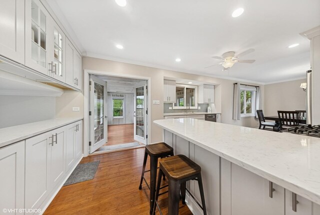 647 Farnham Ln, Wheaton, IL 60189 - kitchen with a breakfast bar, ornamental molding, white cabinetry, recessed lighting, and a ceiling fan