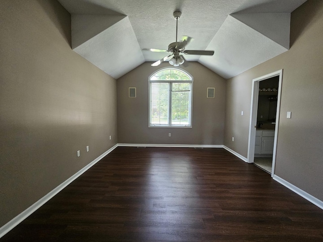 210 Barrington Dr, Bourbonnais, IL 60914 - additional living space featuring a ceiling fan, dark wood-style flooring, lofted ceiling, and a textured ceiling