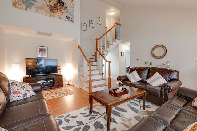 552 Arbor Gate Ln, Buffalo Grove, IL 60089 - living room featuring a high ceiling, wood finished floors, and stairway