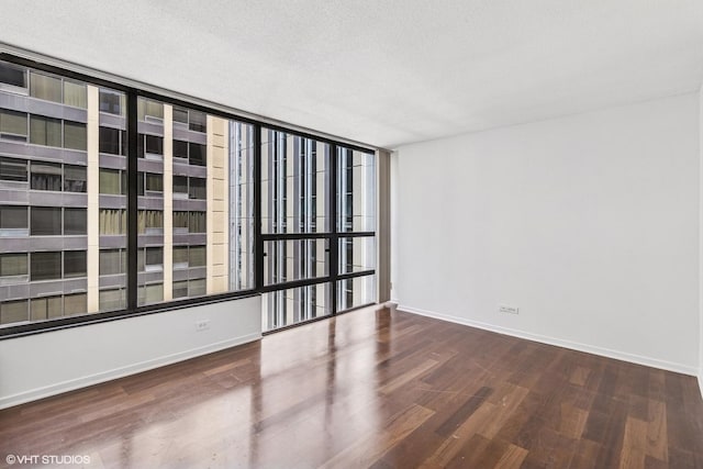 230 E Ontario St Unit 2305, Chicago, IL 60611 - spare room featuring wood finished floors and a textured ceiling