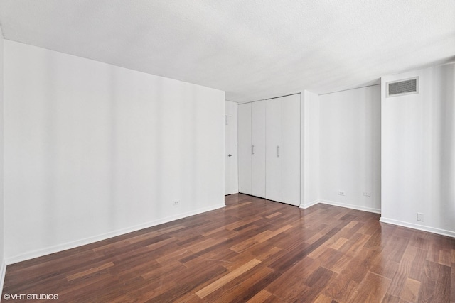 230 E Ontario St Unit 2305, Chicago, IL 60611 - unfurnished bedroom with dark wood-style floors and two closets