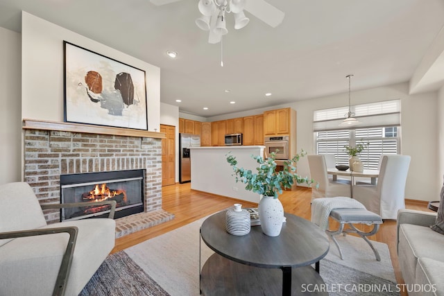 1962 Highbury Ln, Aurora, IL 60502 - living area with light wood finished floors, a fireplace, a ceiling fan, and recessed lighting