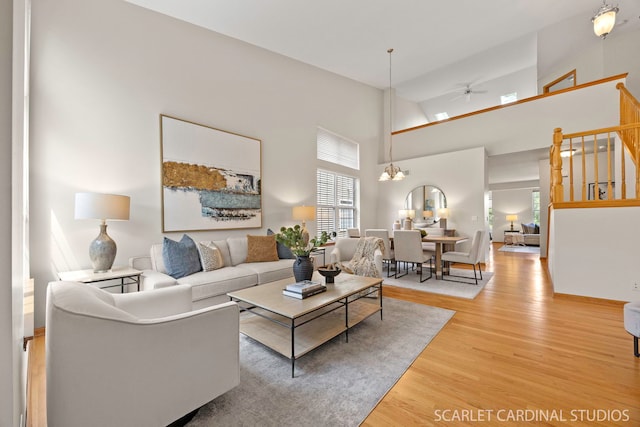 1962 Highbury Ln, Aurora, IL 60502 - living room with ceiling fan, wood finished floors, a towering ceiling, and a chandelier