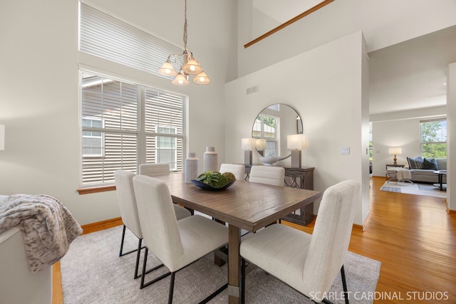 1962 Highbury Ln, Aurora, IL 60502 - dining space featuring a chandelier, light wood finished floors, and a towering ceiling