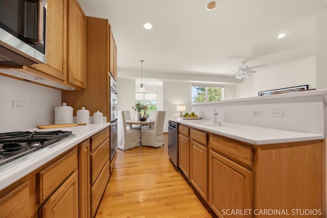 1962 Highbury Ln, Aurora, IL 60502 - kitchen with appliances with stainless steel finishes, light wood-type flooring, light countertops, a ceiling fan, and brown cabinetry