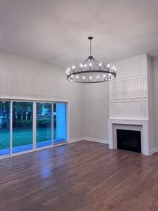 25136 Thornberry Dr Unit 25136, Plainfield, IL 60544 - unfurnished living room with a chandelier, wood finished floors, and a fireplace