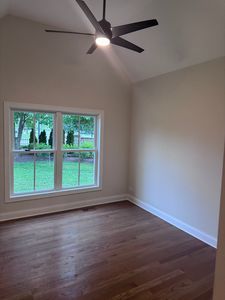 25136 Thornberry Dr Unit 25136, Plainfield, IL 60544 - spare room featuring lofted ceiling, healthy amount of natural light, ceiling fan, and dark wood-type flooring
