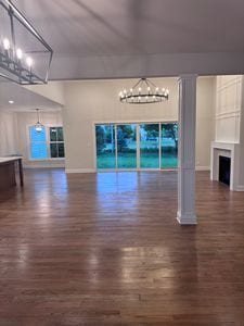 25136 Thornberry Dr Unit 25136, Plainfield, IL 60544 - unfurnished living room with a chandelier, wood finished floors, and a fireplace