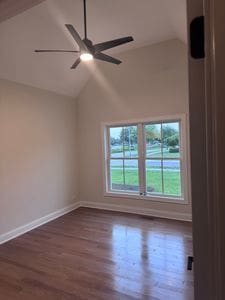 25136 Thornberry Dr Unit 25136, Plainfield, IL 60544 - empty room featuring vaulted ceiling, a ceiling fan, and wood finished floors