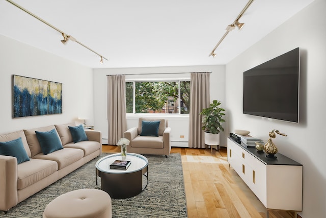 1050 W Columbia Ave Unit 3F, Chicago, IL 60626 - living room featuring rail lighting, light wood finished floors, and a baseboard radiator