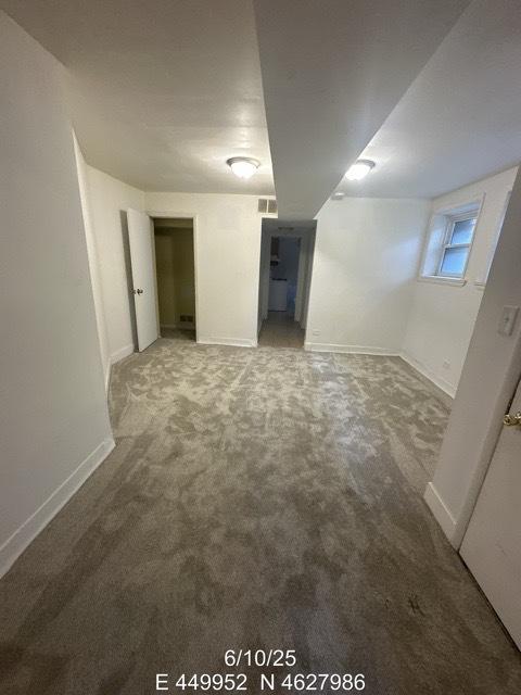 947 E Hyde Park Blvd Unit G, Chicago, IL 60615 - carpeted empty room with baseboards