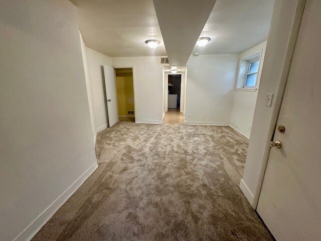 947 E Hyde Park Blvd Unit G, Chicago, IL 60615 - unfurnished room with carpet flooring and baseboards