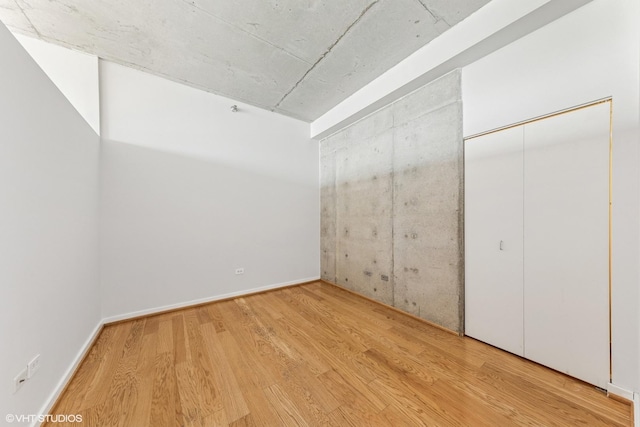 1720 S Michigan Ave Unit 2106, Chicago, IL 60616 - unfurnished bedroom featuring wood finished floors and a closet