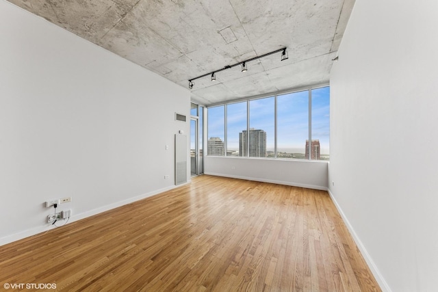 1720 S Michigan Ave Unit 2106, Chicago, IL 60616 - empty room with rail lighting, wood-type flooring, and a view of city