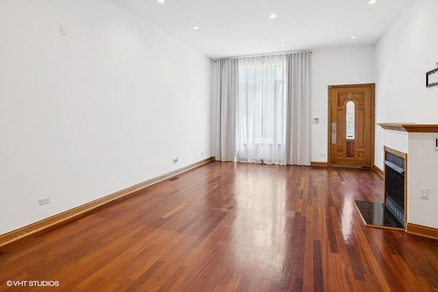 1644 W Lemoyne St Unit 1, Chicago, IL 60622 - unfurnished living room featuring a tiled fireplace, wood finished floors, and recessed lighting