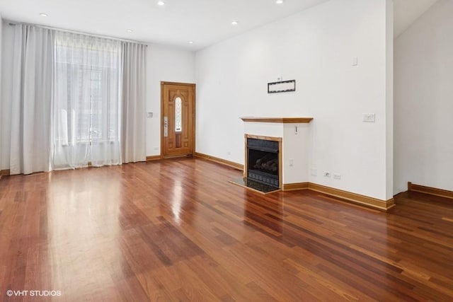 1644 W Lemoyne St Unit 1, Chicago, IL 60622 - unfurnished living room featuring wood finished floors, a tiled fireplace, and recessed lighting
