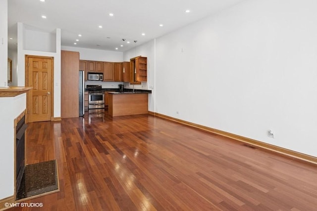 1644 W Lemoyne St Unit 1, Chicago, IL 60622 - kitchen featuring appliances with stainless steel finishes, open shelves, dark countertops, dark wood-type flooring, and recessed lighting