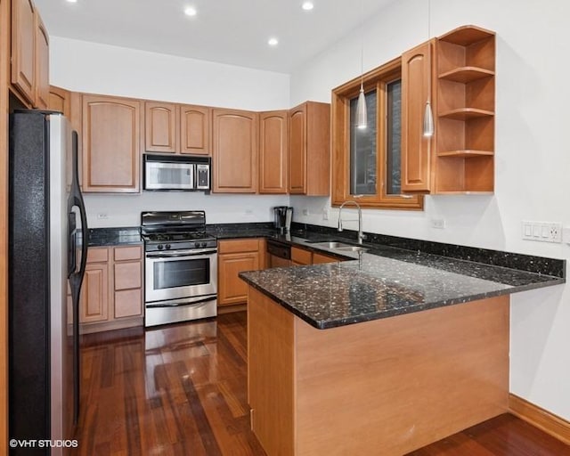 1644 W Lemoyne St Unit 1, Chicago, IL 60622 - kitchen with stainless steel appliances, a peninsula, dark wood-type flooring, dark stone countertops, and recessed lighting
