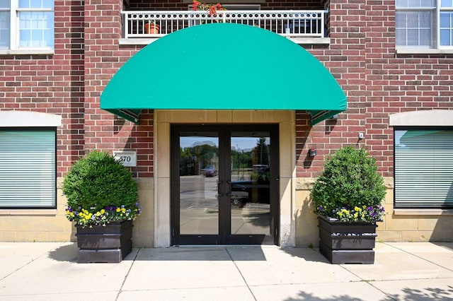 570 Crescent Blvd Unit 307, Glen Ellyn, IL 60137 - property entrance with french doors, brick siding, and a balcony