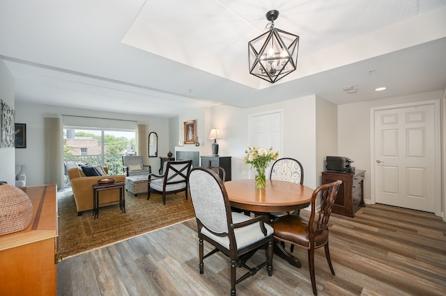 570 Crescent Blvd Unit 307, Glen Ellyn, IL 60137 - dining room with wood finished floors, a chandelier, a tray ceiling, and recessed lighting
