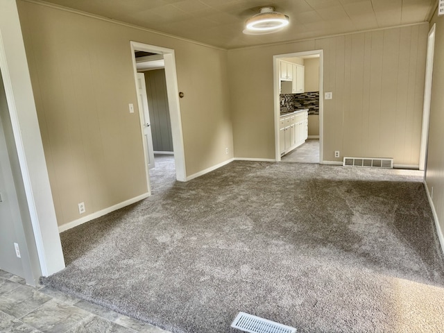 401 E 1st St, Oglesby, IL 61348 - carpeted empty room with baseboards and crown molding