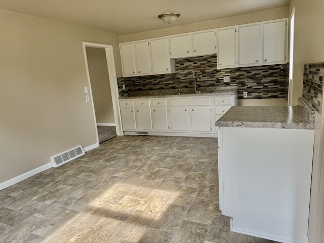 401 E 1st St, Oglesby, IL 61348 - kitchen featuring decorative backsplash and white cabinets