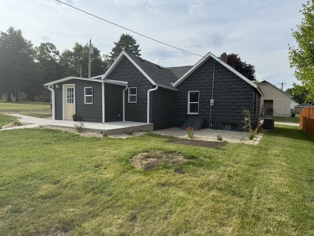 401 E 1st St, Oglesby, IL 61348 - rear view of property featuring a patio, a chimney, a lawn, and stone siding