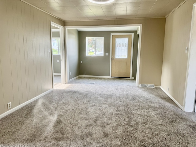 401 E 1st St, Oglesby, IL 61348 - carpeted spare room with crown molding and wooden walls
