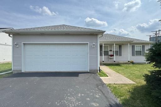 645 Tally St, Earlville, IL 60518 - single story home with asphalt driveway, a front lawn, an attached garage, and a porch