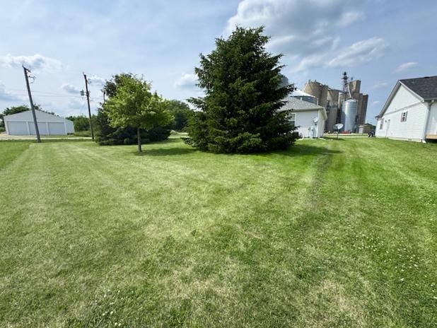 645 Tally St, Earlville, IL 60518 - view of grassy yard with a garage