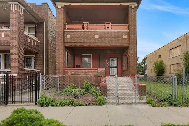 5440 S Paulina St, Chicago, IL 60609 - multi unit property featuring brick siding, a gate, a fenced front yard, and a balcony