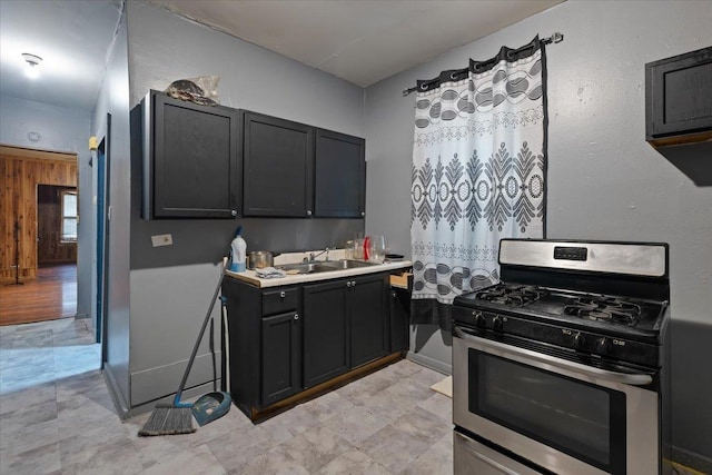 5440 S Paulina St, Chicago, IL 60609 - kitchen with stainless steel range with gas cooktop, light countertops, and dark cabinets