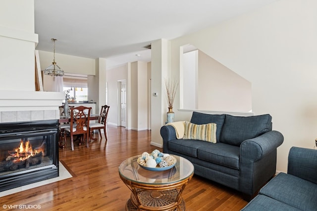 2396 Oakfield Ct, Aurora, IL 60503 - living area with wood finished floors, a fireplace, and a chandelier