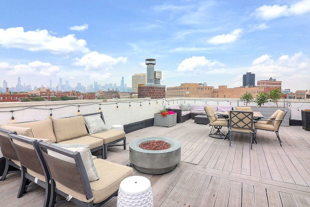 1644 W Blackhawk St Unit 2E, Chicago, IL 60622 - wooden deck featuring an outdoor living space with a fire pit, a skyline view, and outdoor dining area