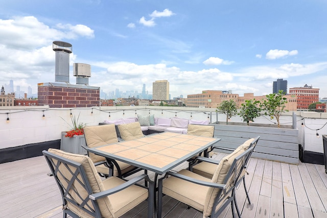1644 W Blackhawk St Unit 2E, Chicago, IL 60622 - wooden deck with a view of skyline and outdoor dining area