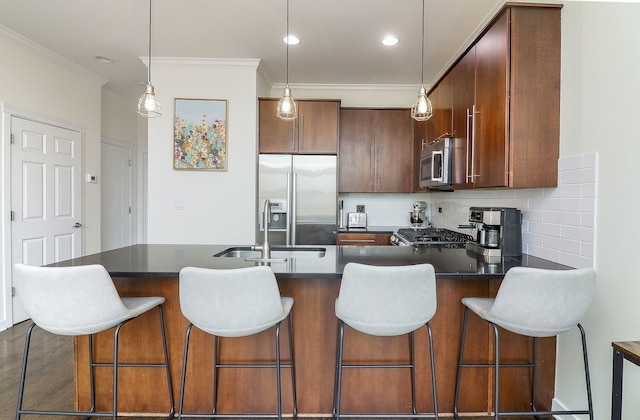 1644 W Blackhawk St Unit 2E, Chicago, IL 60622 - kitchen featuring appliances with stainless steel finishes, ornamental molding, backsplash, dark countertops, and decorative light fixtures
