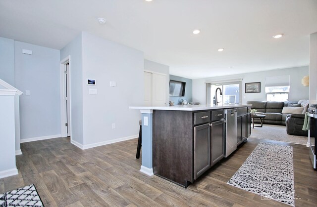 6650 Linden Trl Unit B, Wonder Lake, IL 60097 - kitchen featuring open floor plan, light countertops, wood finished floors, a kitchen island with sink, and recessed lighting
