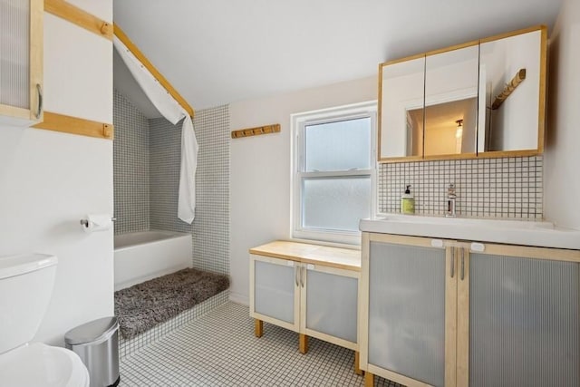 3739 W Palmer St, Chicago, IL 60647 - full bathroom with vanity, a bathtub, backsplash, and vaulted ceiling