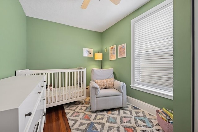 3739 W Palmer St, Chicago, IL 60647 - bedroom featuring a crib, wood finished floors, and ceiling fan