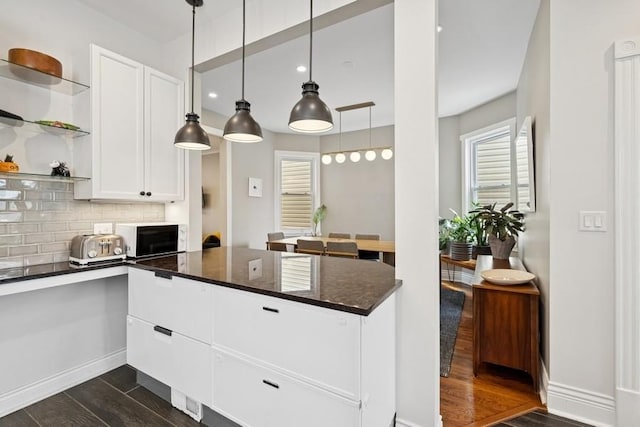 3739 W Palmer St, Chicago, IL 60647 - kitchen featuring a peninsula, dark wood finished floors, white cabinetry, open shelves, and tasteful backsplash
