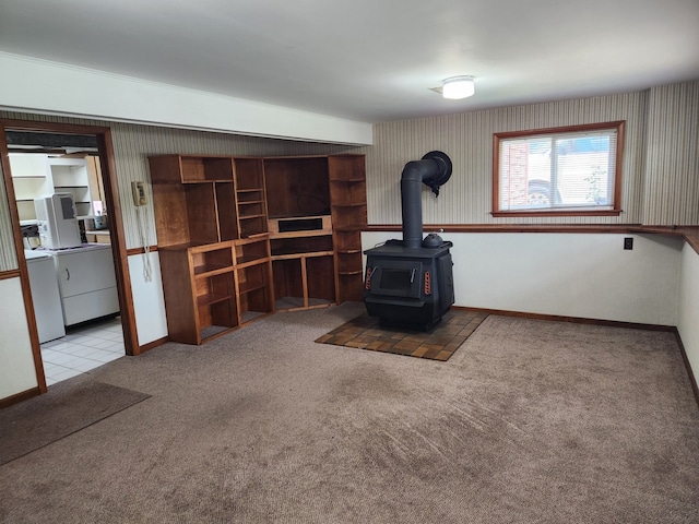 624 Maple Ave, Lisle, IL 60532 - living area with a wood stove, carpet floors, wallpapered walls, and washing machine and dryer