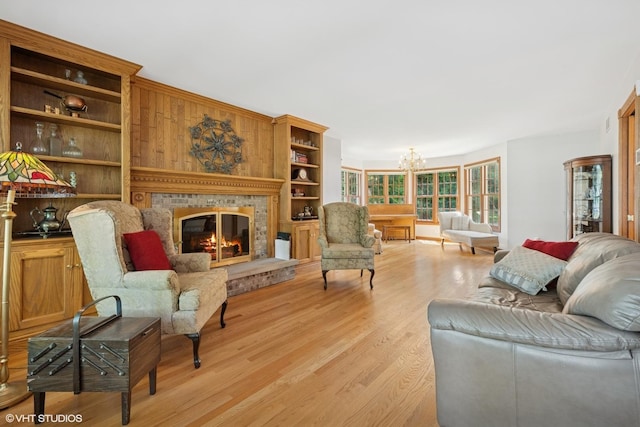 42 N Holly Ave, Fox Lake, IL 60020 - living room with a chandelier, light wood finished floors, and a fireplace