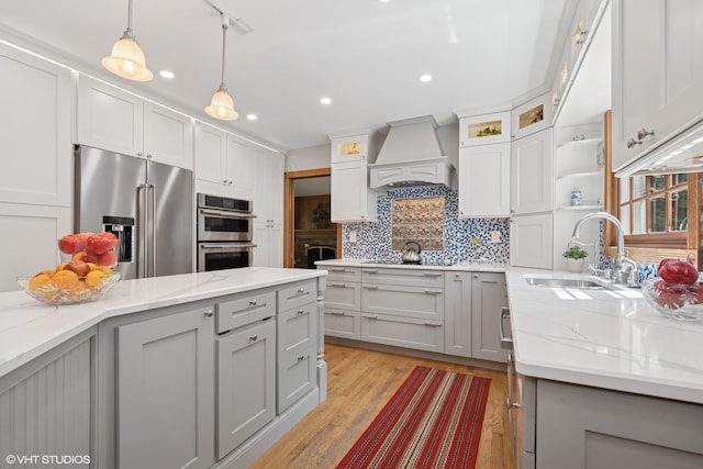 42 N Holly Ave, Fox Lake, IL 60020 - kitchen with appliances with stainless steel finishes, custom range hood, gray cabinets, backsplash, and pendant lighting