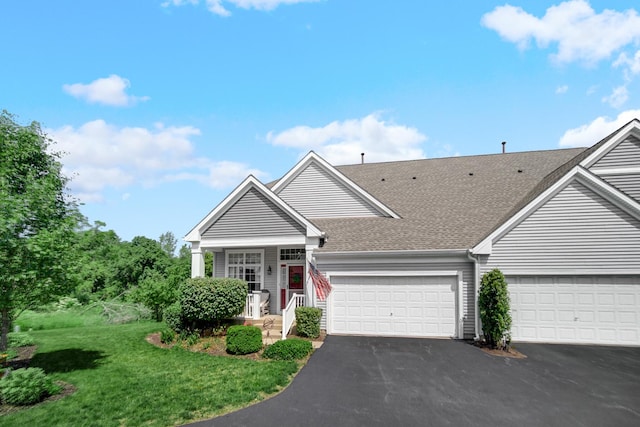 361 Cascade Ln Unit 1, Oswego, IL 60543 - view of front facade featuring a shingled roof, asphalt driveway, a front lawn, and a garage