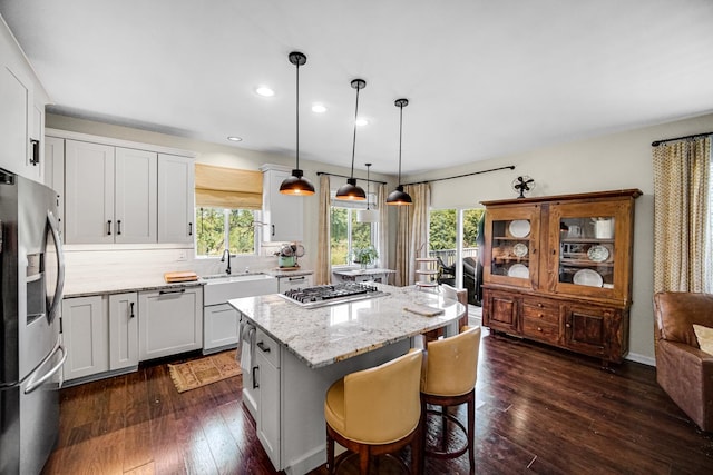 361 Cascade Ln Unit 1, Oswego, IL 60543 - kitchen featuring stainless steel appliances, a center island, plenty of natural light, recessed lighting, and light stone counters