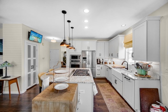 361 Cascade Ln Unit 1, Oswego, IL 60543 - kitchen with stainless steel appliances, a center island, dark wood finished floors, white cabinets, and recessed lighting
