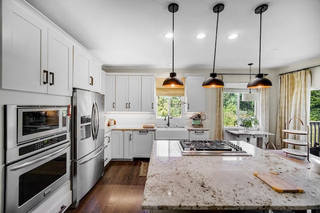 361 Cascade Ln Unit 1, Oswego, IL 60543 - kitchen with appliances with stainless steel finishes, a center island, white cabinets, plenty of natural light, and recessed lighting
